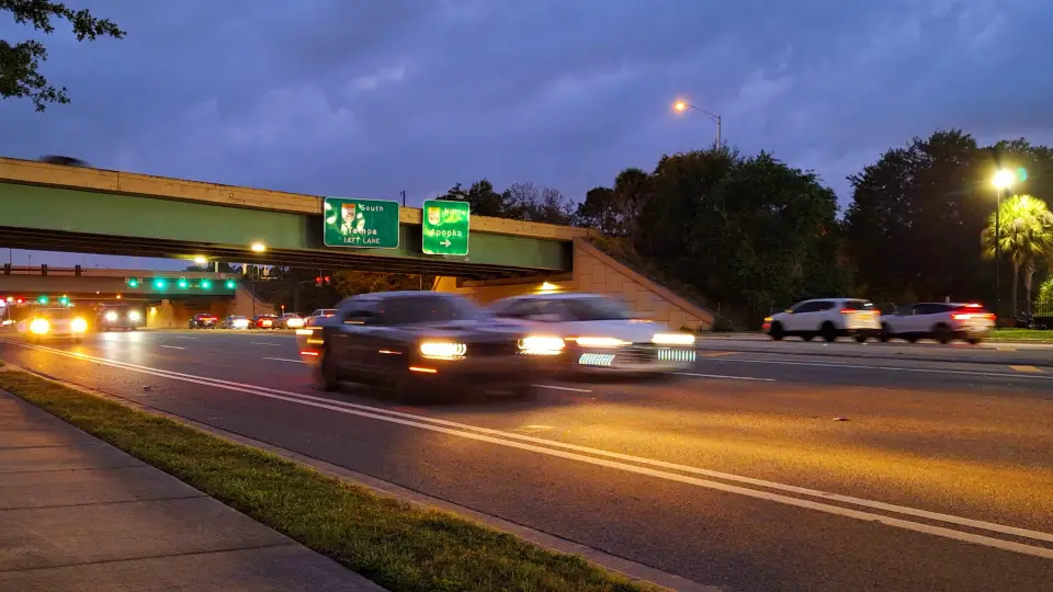 Cars driving by at night on a highway in a Traffic Heaven ambience video