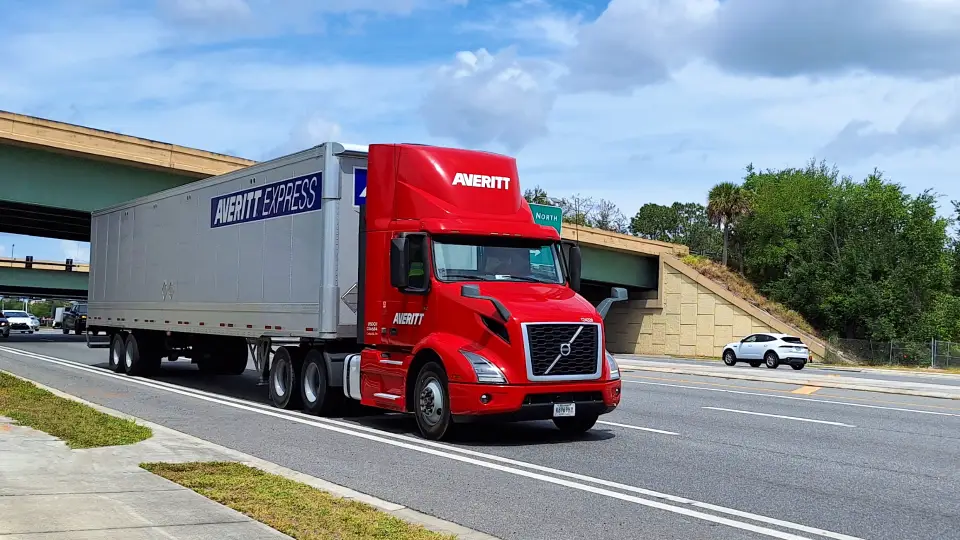 Red semi truck driving by on a highway in a Traffic Heaven video